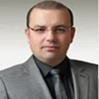 Uzm. Dr. Genco Usta — Çocuk ve Ergen Psikiyatrisi, Ankara. Portre fotoğrafı.